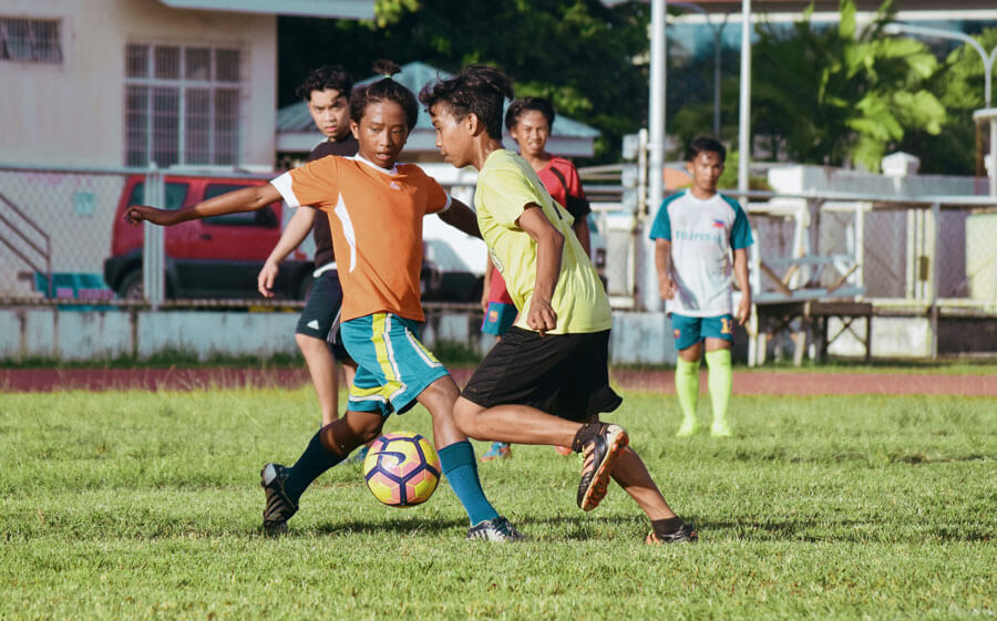 Teenage footballers on a pitch